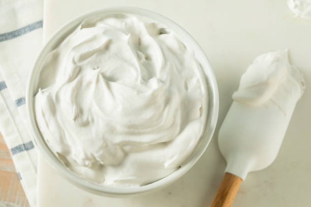 Creamy homemade American buttercream frosting swirled on a cupcake